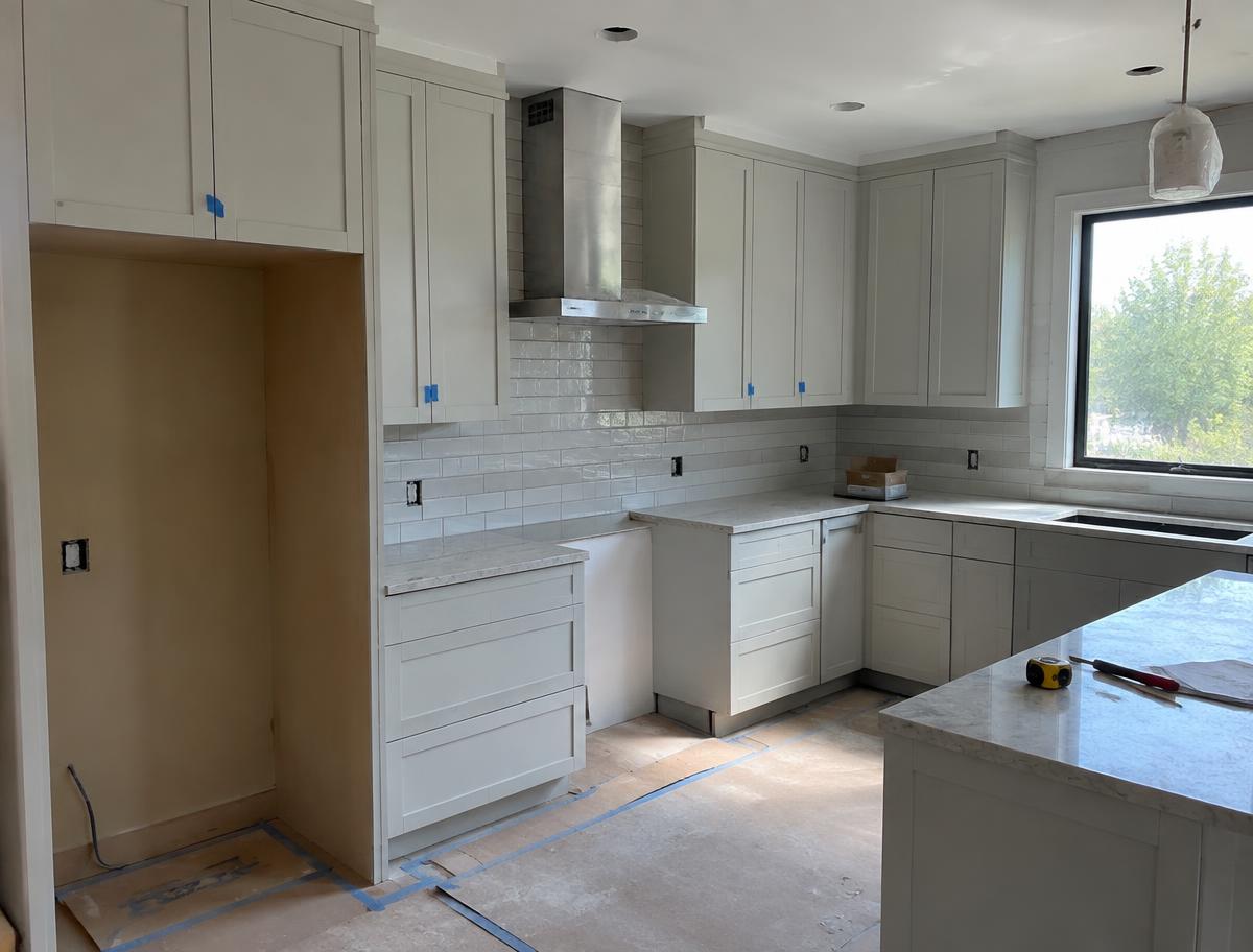 Cocina en reforma con muebles nuevos y alicatado blanco